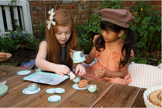 Two children enjoying afternoon tea with the Weekend and Paris Tin Tea Set. 